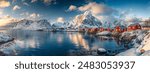 Panorama of Scandinavian village with snow mountain at coastline in morning. Lofoten islands, Norway