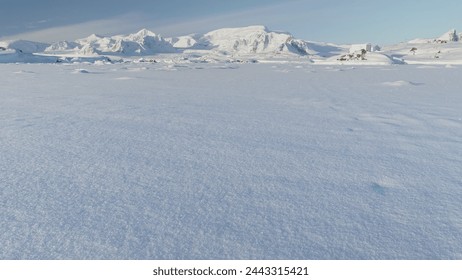 Panorama of scientific base in Infinitely, Infinitely polar snowy Antarctica desert. South Pole frost surface. Snow covered mountains on horizon. Aerial view flight. Ice Landscape. Winter frozen - Powered by Shutterstock