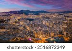 Panorama of Seoul city skyline and skyscrapers at night with Namsan Mountain and Bukhansan in the background, Seoul, South Korea.