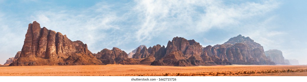 Panorama of Seven Pillars of Wisdom rock formation as seen from visitor centre in Wadi Rum protected desert, Jordan - Shutterstock ID 1662715726