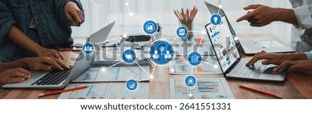Panorama shot analyst team utilizing BI Fintech to analyze financial report with laptop. Businesspeople analyzing BI power dashboard displayed on laptop screen for business insight. Scrutinize Amity