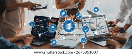 Panorama shot analyst team utilizing BI Fintech to analyze financial report with laptop. Businesspeople analyzing BI power dashboard displayed on laptop screen for business insight. Scrutinize Amity