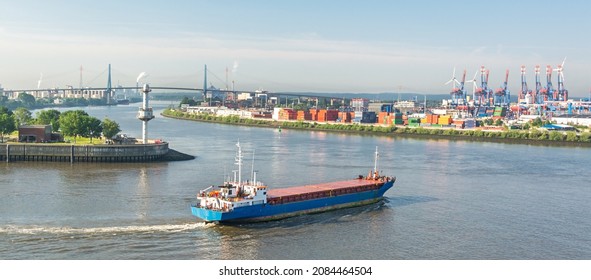 Panorama shot of container vessel steering towards the harbour and container terminal at the Elbe river in Hamburg
