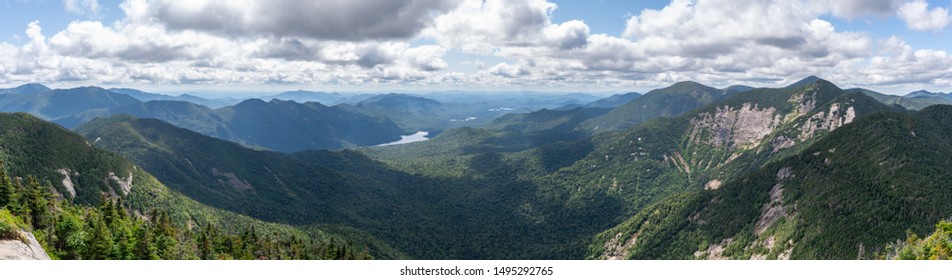 Panorama shot from the summit of the Ghotics Mountain on a sunny day. Beautiful view of the forest, valleys and many peaks. Shot in the Adirondacks National Park, NY, USA. 
