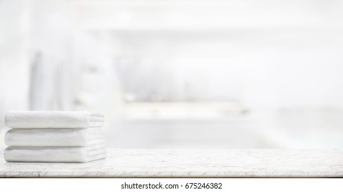  panorama shot : Towels on marble top table with copy space on blurred bathroom background. For product display montage. - Shutterstock ID 675246382