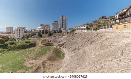 Panorama showing the Amphitheatre of Durres (Amphitheatrum Dyrrhachium) timelapse from above. Ruins of the ancient Roman amphitheater in the center of Durres, Albania.