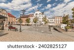 Panorama showing Neptune fountain on Old Town Market Square timelapse with historical houses around. Many cafes with umbrellas. Old town in Bielsko-Biala city, Poland