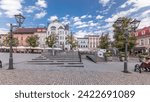 Panorama showing Neptune fountain on Old Town Market Square timelapse with historical houses around. Many cafes with umbrellas. Old town in Bielsko-Biala city, Poland