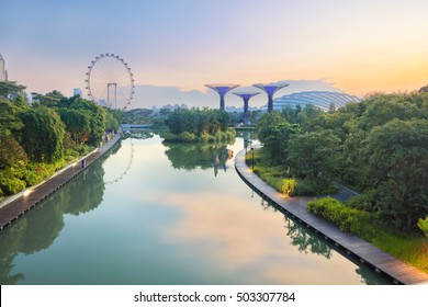 Panorama Of Singapore Gardens With Pond At Sunrise