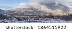 Panorama snow covered winter view of Nelson, B.C. Canada along the West Arm of the Kootenay Lake with snowy mountain backdrop.