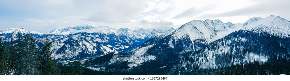 Panorama of snow-capped mountains, snow and clouds on the horizon - Powered by Shutterstock