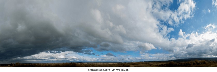 Panorama of sunny and stormy sky on a background of mountains - Powered by Shutterstock