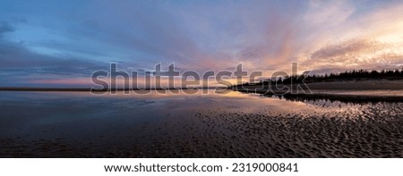 Panorama of sunset at low tide on beach at Cape Fife, Haida Gwaii, BC, Canada