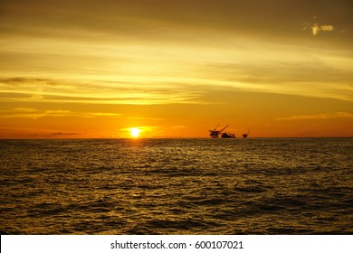 Panorama of the sunset on the sky with silhouette of offshore platform at South China Sea.