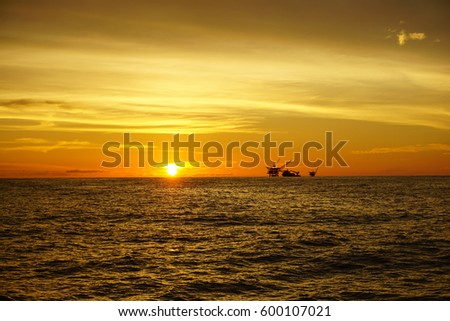 Panorama of the sunset on the sky with silhouette of offshore platform at South China Sea.