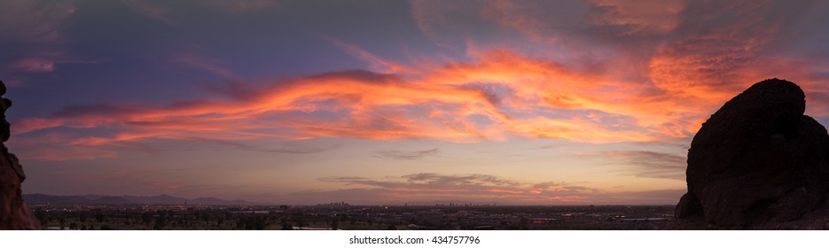 Panorama of sunset over late evening red sky over Phoenix,Arizona.  Papago Park buttes in foreground.