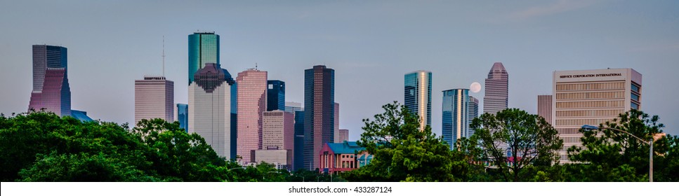 A Panorama Of A Super Moon, Full Moon Rising Over The City Of Houston, TX Skyline Behind All Of The Cities Skyscrapers.