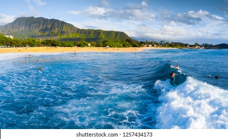 Panorama of the surf spot Makaha with the surfer riding the wave. Oahu, Hawaii