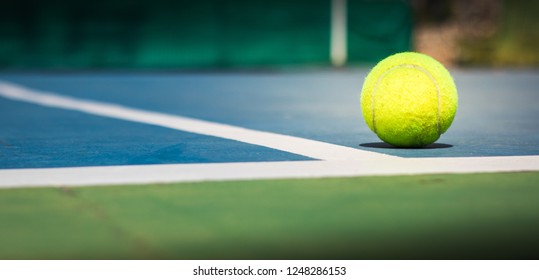 Panorama, tennis balls in court on corner blue floor