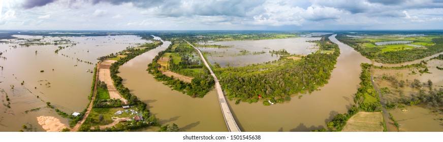 Panorama Top view Aerial photo from flying drone.Flooded rice paddies and village.Flooding the fields with water in which rice sown. View from above,Moon river,Sisaket province,Thailand,ASIA.