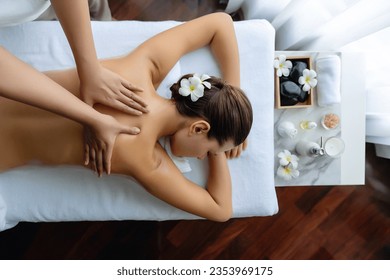 Panorama top view woman customer enjoying relaxing anti-stress spa massage and pampering with beauty skin recreation leisure in day light ambient salon spa at luxury resort or hotel. Quiescent - Powered by Shutterstock