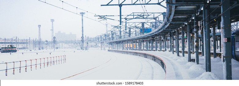 Panorama of train platform in snow fall, snow strom in winter, heavy snow is transport obstacle make train delay time. Hakodate, Hokkaido, Japan