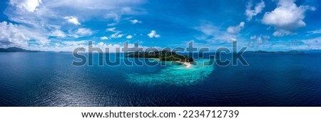 Panorama of a tropical island in the ocean. Tropical sea island panorama. Tropical sea island panoramic landscape. Sea island panorama