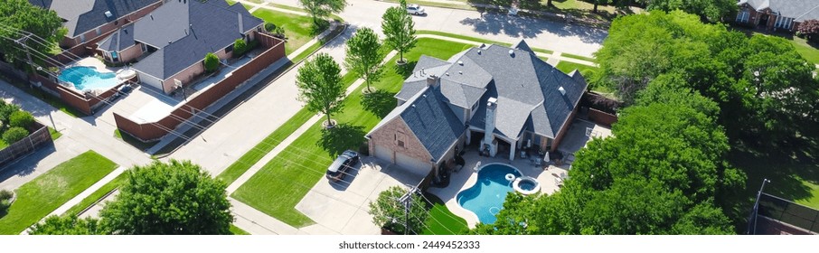 Panorama two story suburban single-family home with swimming pool, large backyard, tall wooden fence, suburb Dallas, TX subdivision, upscale house lush green tree, well-trimmed landscape, aerial. USA - Powered by Shutterstock