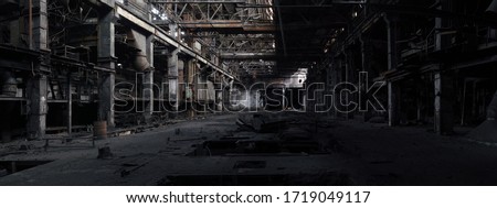 Panorama of an unlit abandoned interior in a closed bankrupt factory. High resolution and detail.