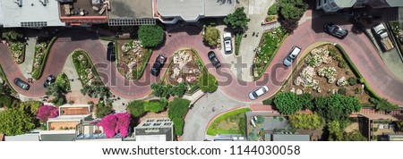 Panorama view aerial Lombard Street, an east–west street in San Francisco, California. Famous for steep, one-block section with eight hairpin turns. Crookedest, steep hills, sharp curves, one-way road