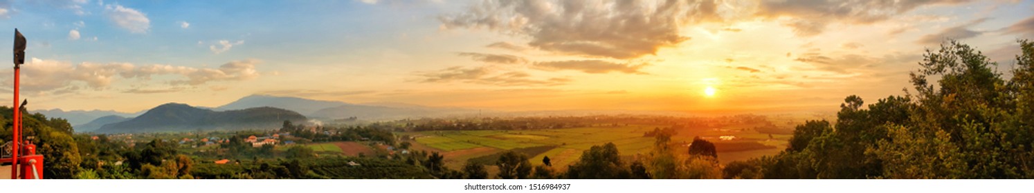 Panorama view of beautiful sunrise over rice field,village and mountain, Beautiful sunrise sky background.Chiang mai, Thailand.