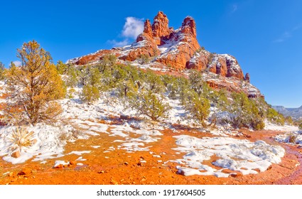 Panorama view of Bell Rock in Sedona Arizona covered in winter snow that is quickly melting.