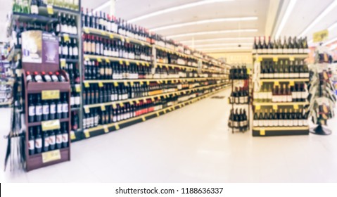 Panorama View Blurred Wine Aisle With Price Tags At Grocery Store In Texas, America. Defocused Rows Of Red, White Wine Liquor Bottles On Supermarket Shelf. Alcoholic Beverage Abstract Background