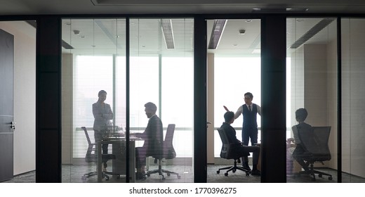 panorama view of busy asian business people working meeting having discussion in modern office