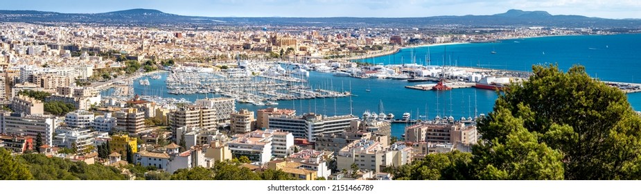 Panorama view from elevated castle Castell de Bellver over the bay of Palma de Mallorca with old town, cathedral La Seu, marina and harbor to the airport and beach Playa Ciudad Jardin at the horizon.