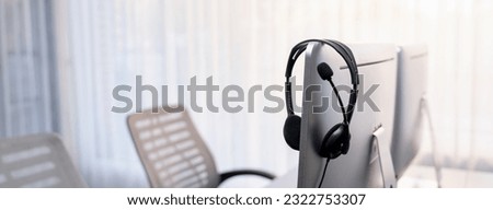 Panorama view of empty call center operator workspace, focused on headset. Representing corporate customer service support and telesales communication technology. Prodigy