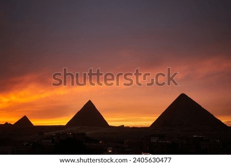 Panorama view of the Giza pyramids during dramatic sunset