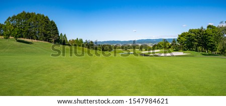 Panorama View of Golf Course with beautiful fairway field. Golf course with a rich green turf beautiful scenery.