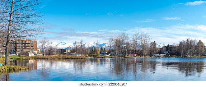 Panorama View Lakeside Apartment Complex And Vacation Home, Float Planes On Lake Spenard With Snow Cap Chugach Mountain Anchorage, AK. State-owned And The World Busiest Seaplane Base