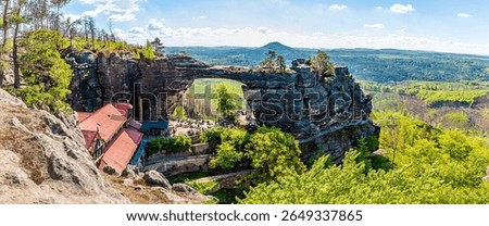 A panorama view of looking down over the Pravcicka Gate arch in springtime