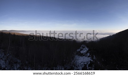 Panorama view of low clouds under mountains, inversion weather in the Czech Republic