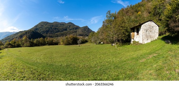 A Panorama View Of A Mountain Landscape In The Julian Alps With A Stone Cottage And Hiking Trail