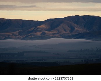 Panorama view of mountain range with low hanging clouds along Highway 79 between Fairline and Geraldine Timaru Canterbury South Island New Zealand