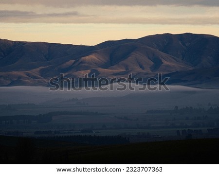Panorama view of mountain range with low hanging clouds along Highway 79 between Fairline and Geraldine Timaru Canterbury South Island New Zealand