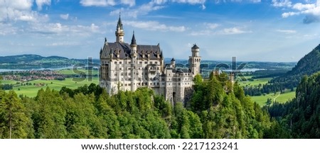Panorama view of Neuschwanstein castle with forest, hill and horizon in nice weather