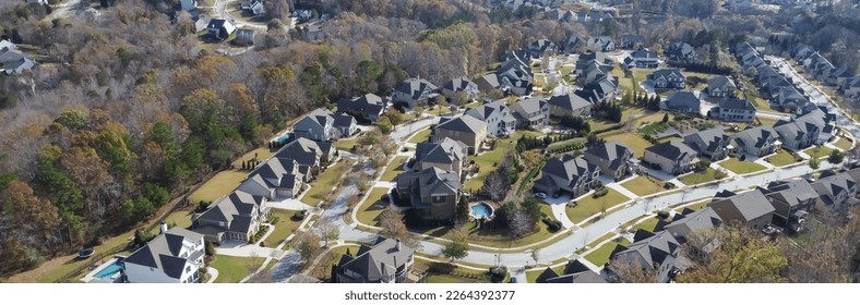 Panorama view row of new developments houses in master planned subdivision with lush green trees and natural trails outside Atlanta, Georgia, US. Aerial urban sprawl suburban residential neighborhood
