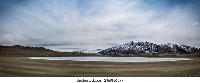 Panorama view of semi-frozen Kyagar Tso Lake, surrounded by snow-capped mountains - Powered by Shutterstock