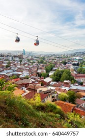 Panorama View Of Tbilisi, Capital Of Georgia Country. Cable Road Above Tiled Roofs. Spring Sunny Day.