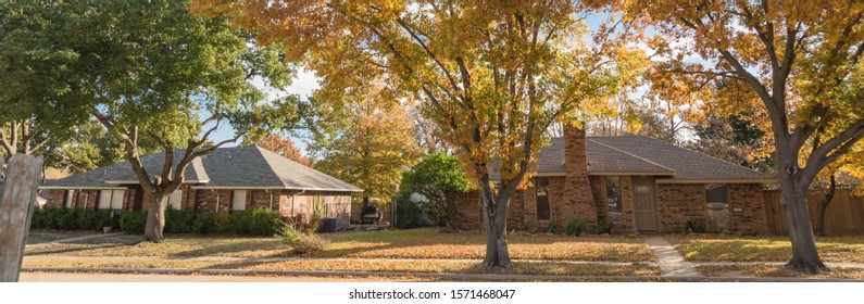 Panorama View Typical Bungalow Style House In Dallas, Texas Suburbs During Fall Season With Colorful Autumn Leaves. Middle Class Neighborhood Single Story Residential Home With Mature Tree