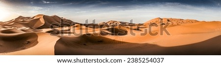 Panorama view of the vast sand dune desert landscape of Erg Chebbi during sunrise. Beautiful nature. Impressive landscape. Desert sunset with high dunes. MDC23 Morocco